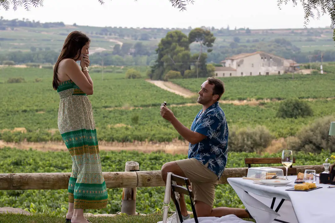 Man proposing to a woman in a private vineyard setting near Barcelona with panoramic views