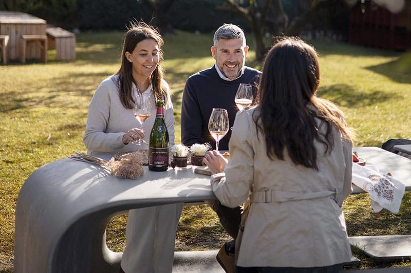 Guests enjoying a cava tasting in the gardens of a Penedès winery near Barcelona