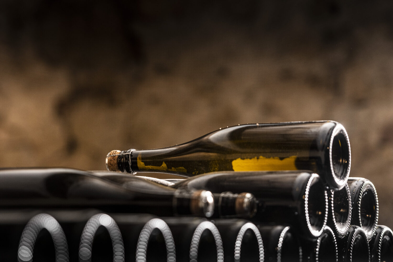 Cava bottles ageing on their lees in a family cellar near Barcelona