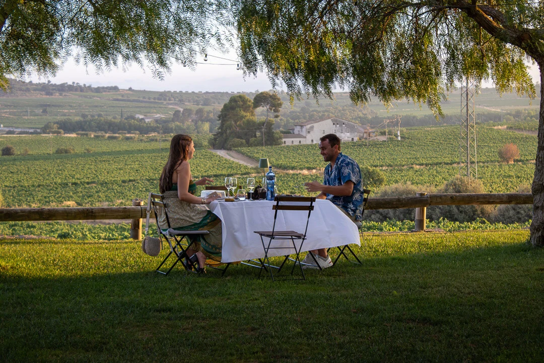 Couple enjoying a private romantic dinner in the vineyards near Barcelona with Montserrat views